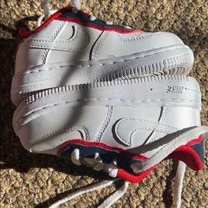 A pair of white red Nike Air Force 1 6c sneakers